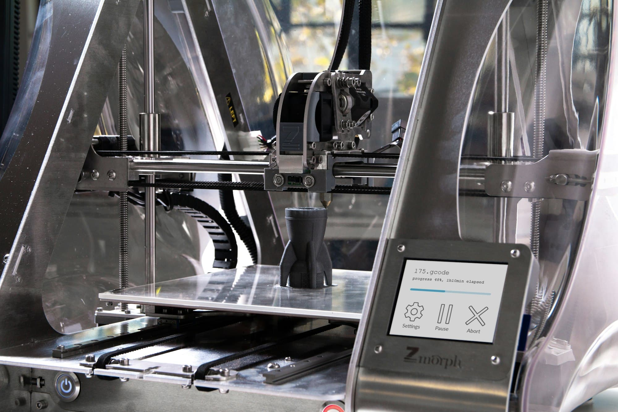 Enclosed 3D printer with a part on its build platform